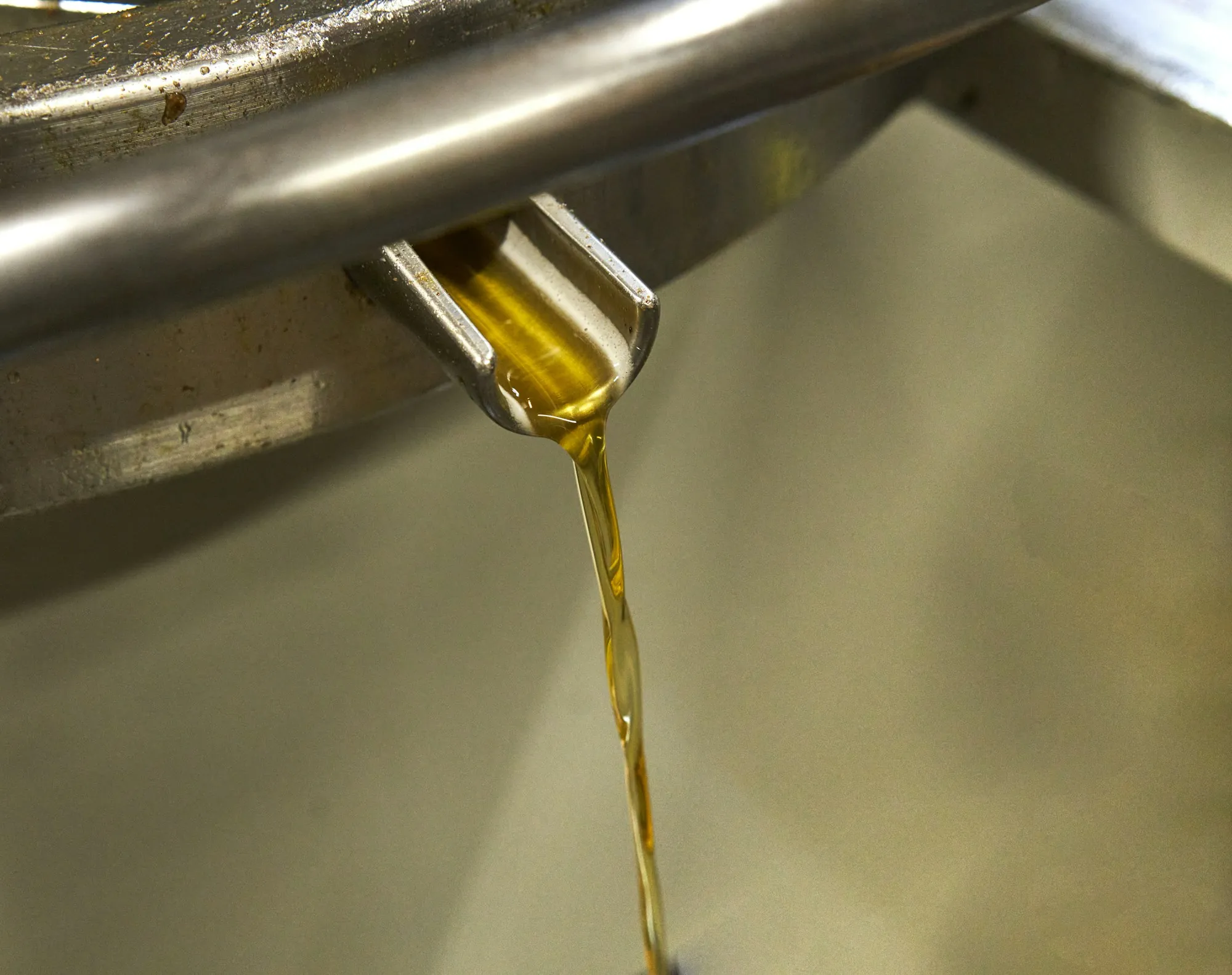 Golden motor oil being poured into an engine
