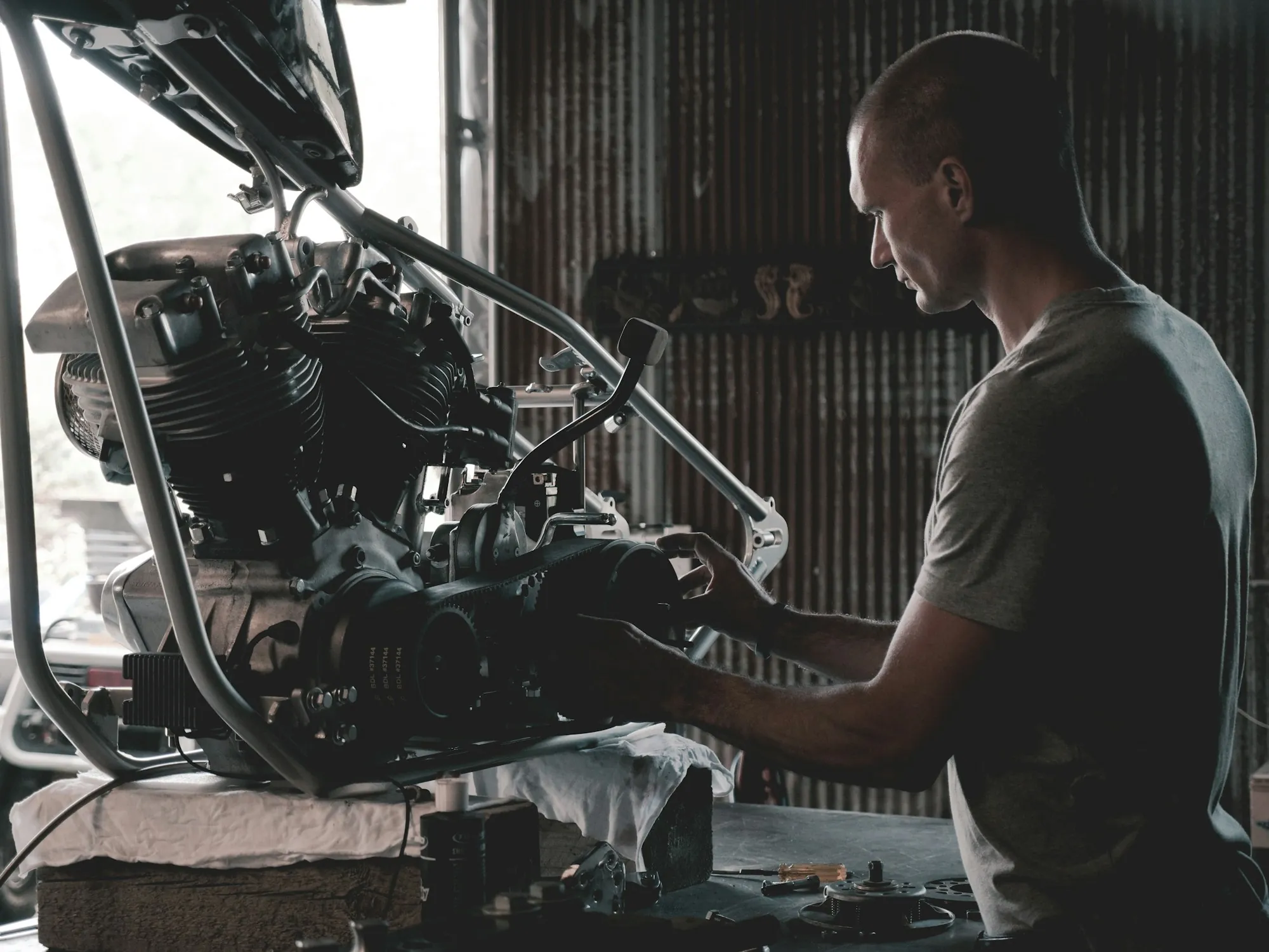 Mechanic lifting a cylinder head from an engine